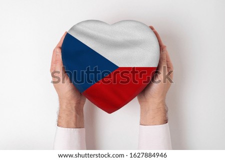 Flag of Czech Republic on a heart shaped box in a male hands. White background