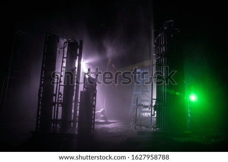 Oil pump and oil refining factory at night with fog and backlight. Energy industrial concept. Selective focus. Artwork decoration.