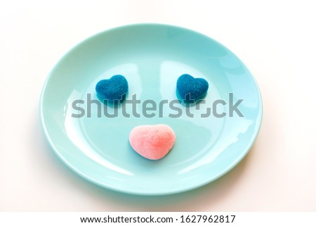 Marmalade and jelly candies sugar hearts blue and pink. Funny muzzle on a turquoise plate. Valentine's classic Day Party Concept. Treats mint for guest children holiday birthday. Edible kids fun 