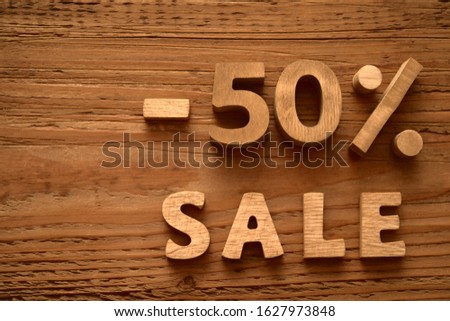 minus 50 Fifty percent sale - wooden letters and digits lie on wood board. empty copy space for inscription. Black friday idea. 
