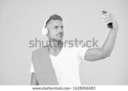 Selfie in gym concept. Sportsman smartphone and headphones. Healthy lifestyle. Gym aesthetics. Mature but still in good shape. Exercising in gym for better health. Man athlete taking selfie photo.
