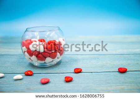 Heart shape candy on blue wood background. Valentines day concept.	