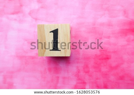 NO.1 made with wooden block on pink paper