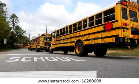 School buses lined up at school crosswalk