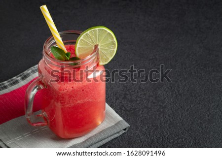Watermelon smoothie with lime and mint in mug jar on a cutting board. Healthy eating concept, copyspace