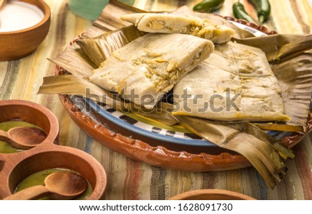 Tamales Oaxaqueños, Mexican dish made with corn dough, chicken or pork and chili, wrapped in a banana leaves.
