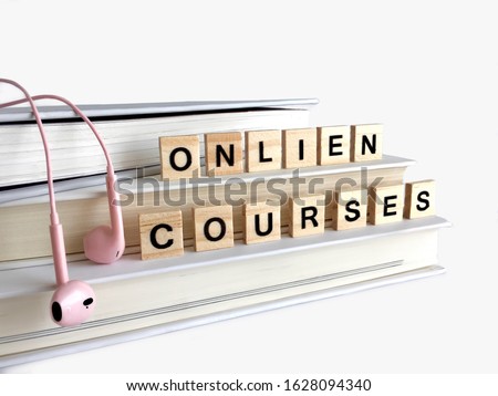 E-learning and online course concept. with black wooden letters of Online Courses words on books.