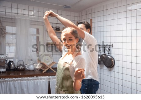 Dancing couple  in the kitchen . Romantic couple at home . Happy young couple .