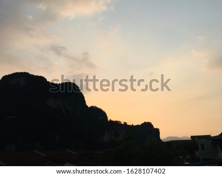 silhouetted mount with orange and blue sky. 