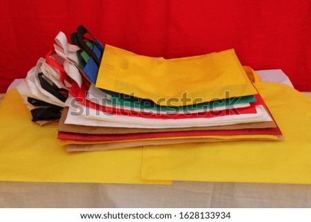 Amazing Colored Shopping Bags Laying on table . Eco Friendly Tote Colorful Bags with Valentine Day red background. Gift and Grocery Bags. Reduce, Reuse, Recycle, save earth and World Environment Day..