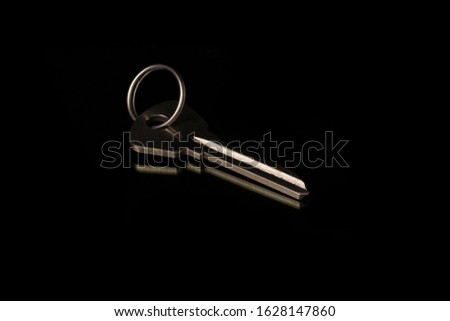 chrome  metal key on black background.