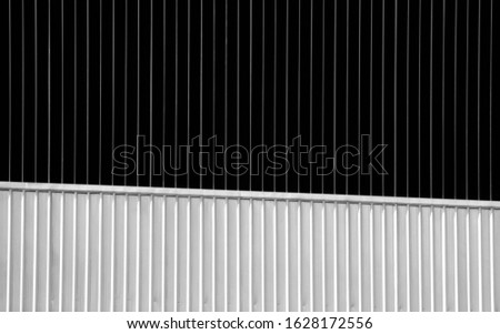 Black and white photography of container wall or corrugated metal. Modern striped geometric pattern of industrial background 