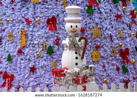 Snow-looking gift package tower. Snowman with gift packages
