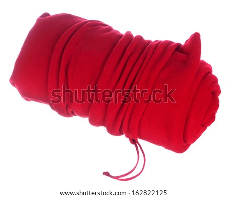 Rolled red blanket in bag isolated on white