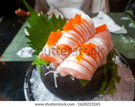 Raw salmon slice or salmon sashimi in Japanese style fresh serve on ice in Japanese restaurant. Royalty-Free Stock Photo #1628223265