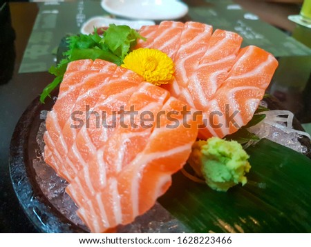 Raw salmon slice or salmon sashimi in Japanese style fresh serve on ice in Japanese restaurant. Royalty-Free Stock Photo #1628223466