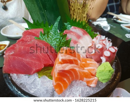 Sashimi set ,Raw salmon, tuna and squid slice in Japanese style fresh serve on ice in Japanese restaurant. Royalty-Free Stock Photo #1628225215