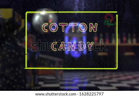 Vintage Neon Cotton Candy Sign in Rainy Window