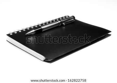 black notebook and pen over a white background