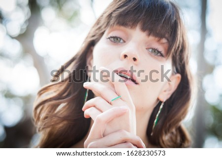 close up Summer fashion portrait of a beautiful young woman or girl on the beach
