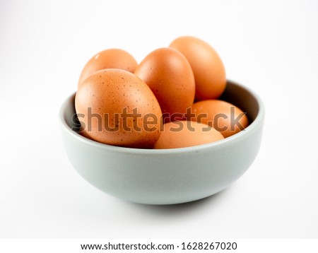 Put eggs in one bowl on white background Royalty-Free Stock Photo #1628267020