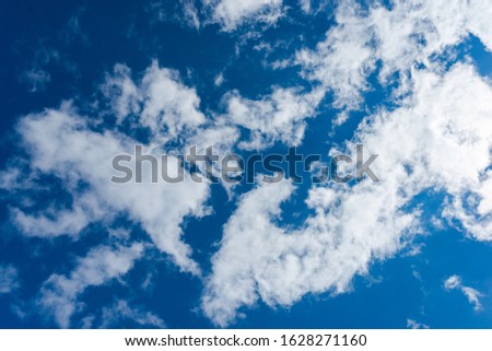 Deep blue sky background with clouds
