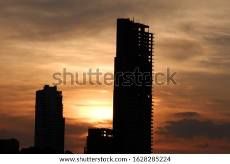 The sun is behind the building before sunset