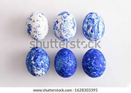 top view six Easter eggs in the color of the year-classic blue with gradient effect in two rows on white background