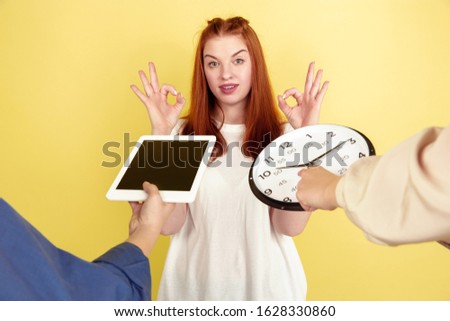 All in time. Caucasian young woman's portrait on yellow studio background, too much tasks. How to manage time right. Concept of office working, business, finance, freelance, self management, planning.