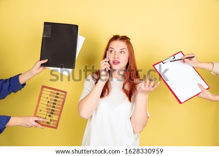 Deadline. Caucasian young woman's portrait on yellow studio background, too much tasks. How to manage time right. Concept of office working, business, finance, freelance, self management, planning.