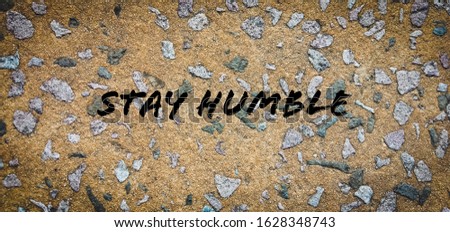 Inspired motivation quotation "Stay Humble" with floor as background. Selected focus. Vintage.