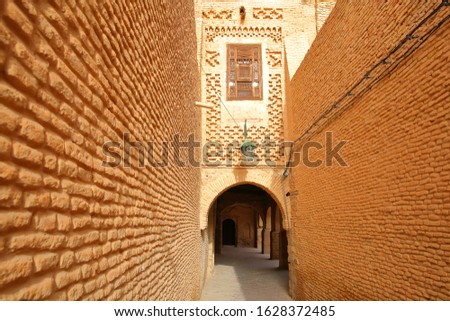 The historical medina of Tozeur (Ouled el Hadef), Tunisia, decorated with patterns of bricks and arcades  Royalty-Free Stock Photo #1628372485