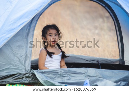 asian little girls alone playing in tent camping travel.