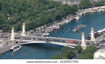 Aerial Shot of Traffic At Pont Alexander III. The Pont Alexandre III is a deck arch bridge connects the Champs Ellysees with the Invalides and Eiffel Tower.