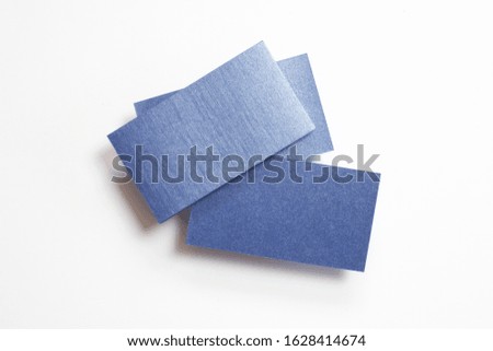 Blank blue linear textured business cards isolated on white, composition concept for presentation, studio shot.