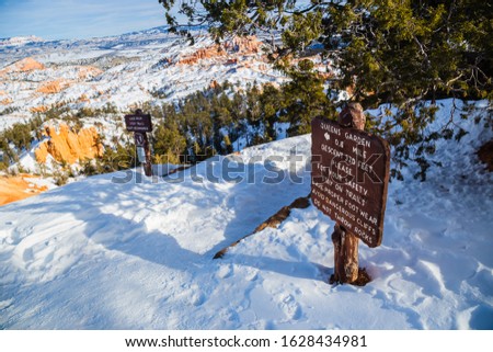 Queen's garden sign post in Bryce Canyon National Park in Winter covered with snow