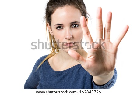 Portrait of young woman making stop sign in front of the camera