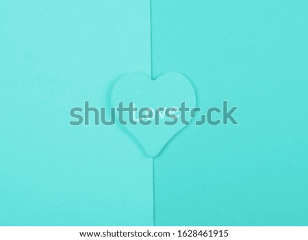 Heart with the word Love on blank pages of a book, top view, minimalist style (cyan color)