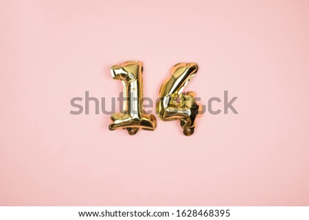 Gold foil balloons numeral 14 on pink background. Happy Valentines Day