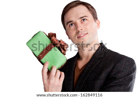 Portrait of a man holding a gift and start thinking about what you