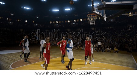 Basketball players on big professional arena during the game. Tense moment of the game.