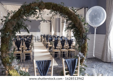 wedding ceremony room with flower arch 