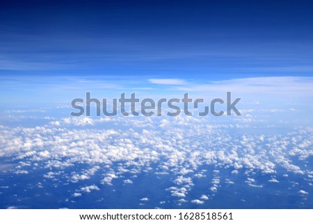 white clouds floating in the blue sky. Aerial view from the space.