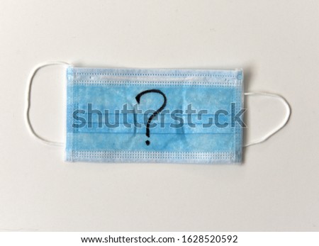 Protective medical mask with sign question mark. Quarantine concept. COVID-19. 