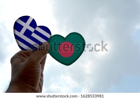 Hand holds a heart Shape Greece and Bangladesh flag, love between two countries
