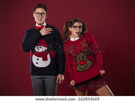 Crazy nerd couple in funny sweaters goofing around Royalty-Free Stock Photo #162854669