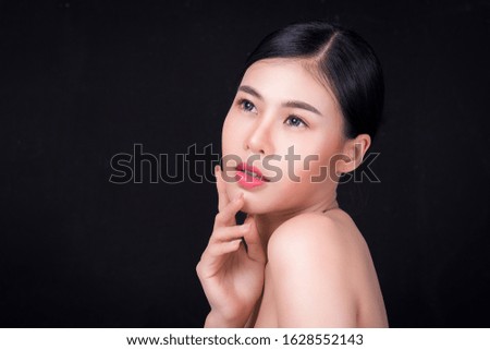 Portrait of a beautiful asian young woman on Gray background. Body language, symbol, gestures, beauty and fashion concept.
