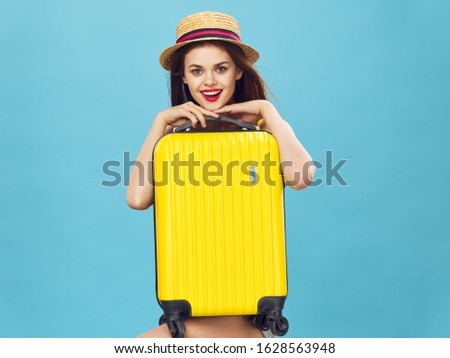beautiful woman with a yellow suitcase on travel airport flight