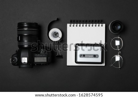 Flat lay composition with equipment for journalist on black background