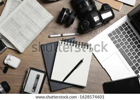 Flat lay composition with equipment for journalist on wooden table